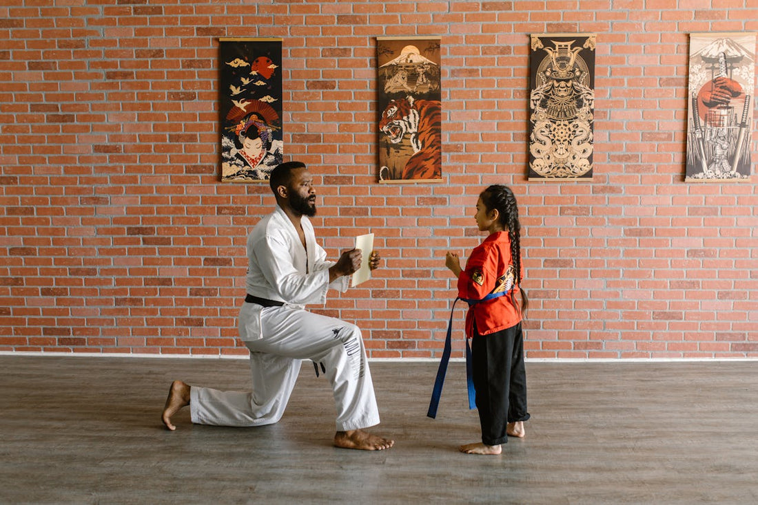 An image showing a BJJ instructor answering questions from a group of students on the mat, with speech bubbles containing common FAQs about training and belts.